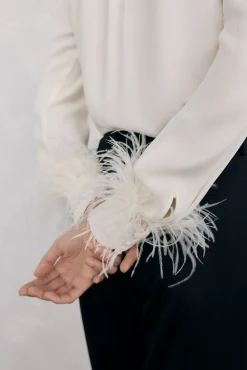 Blusa plumas puño
